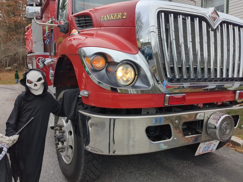 CVS student poses by the fire truck in his grim reaper costume