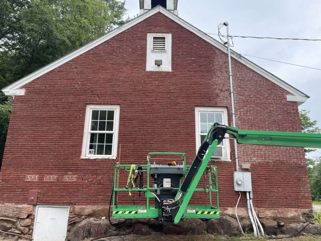 Construction lift near Croydon School District building showing ongoing renovation work.