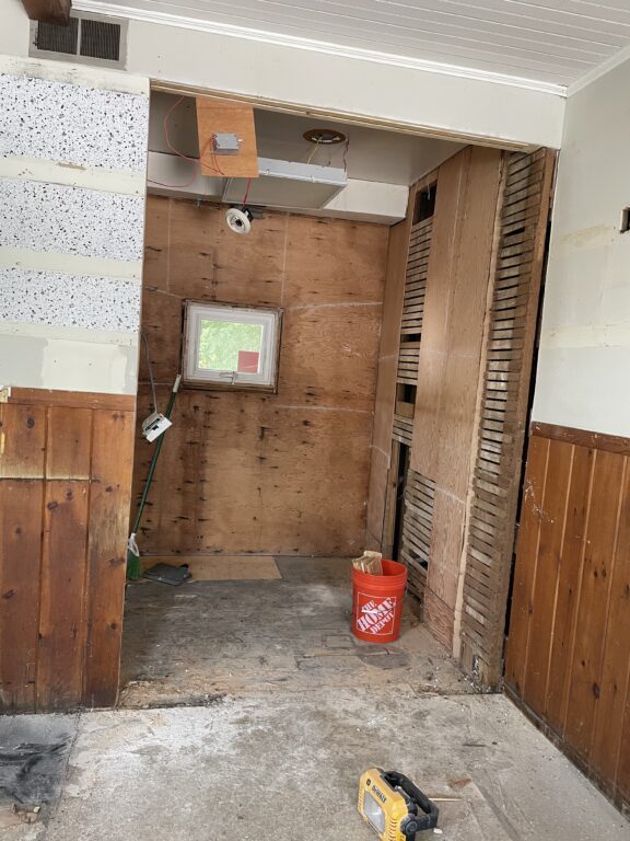 Construction area in Croydon School District with wooden panels and renovation tools.